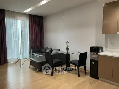 Modern living room with sleek furniture and large window in a stylish apartment.