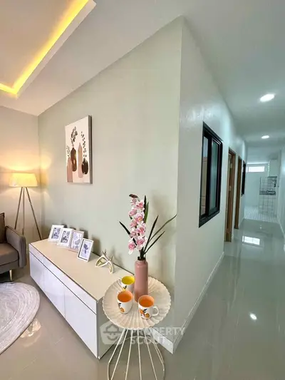 Modern living room with stylish decor and hallway view
