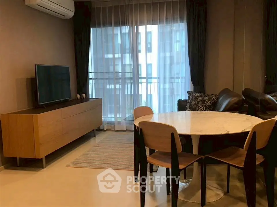 Modern living room with stylish furniture and large window view