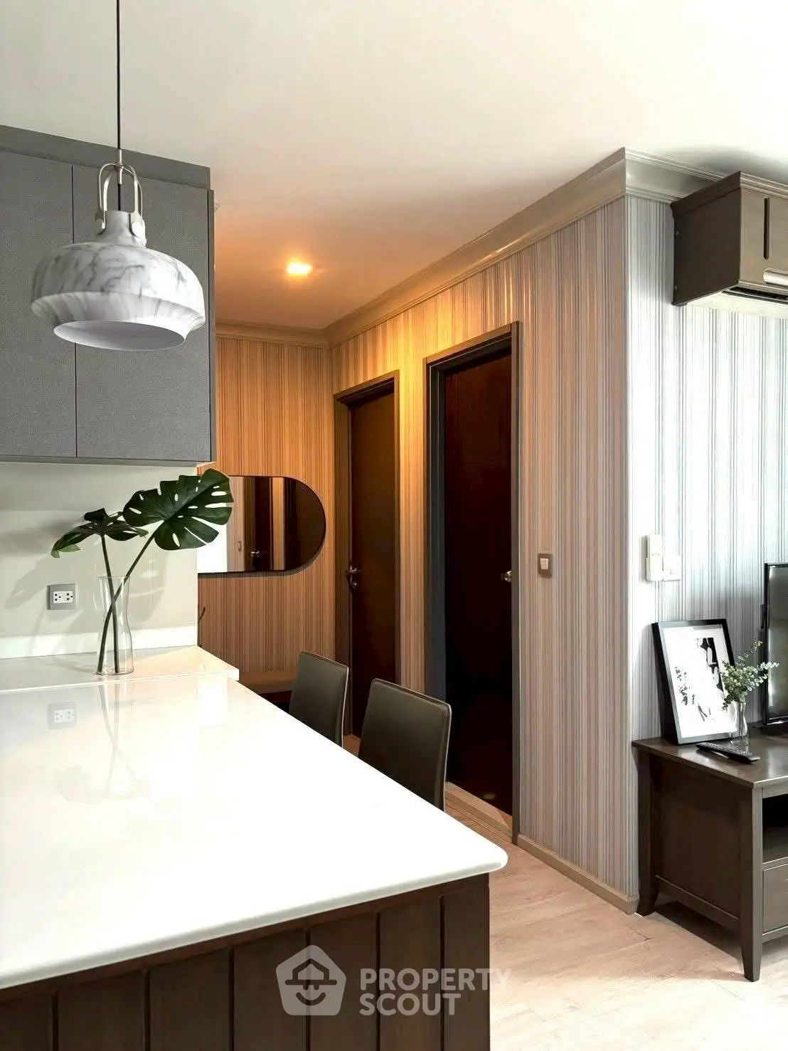 Modern kitchen with sleek design and stylish lighting in a contemporary apartment.