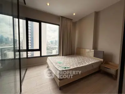 Spacious bedroom with city view in modern high-rise apartment
