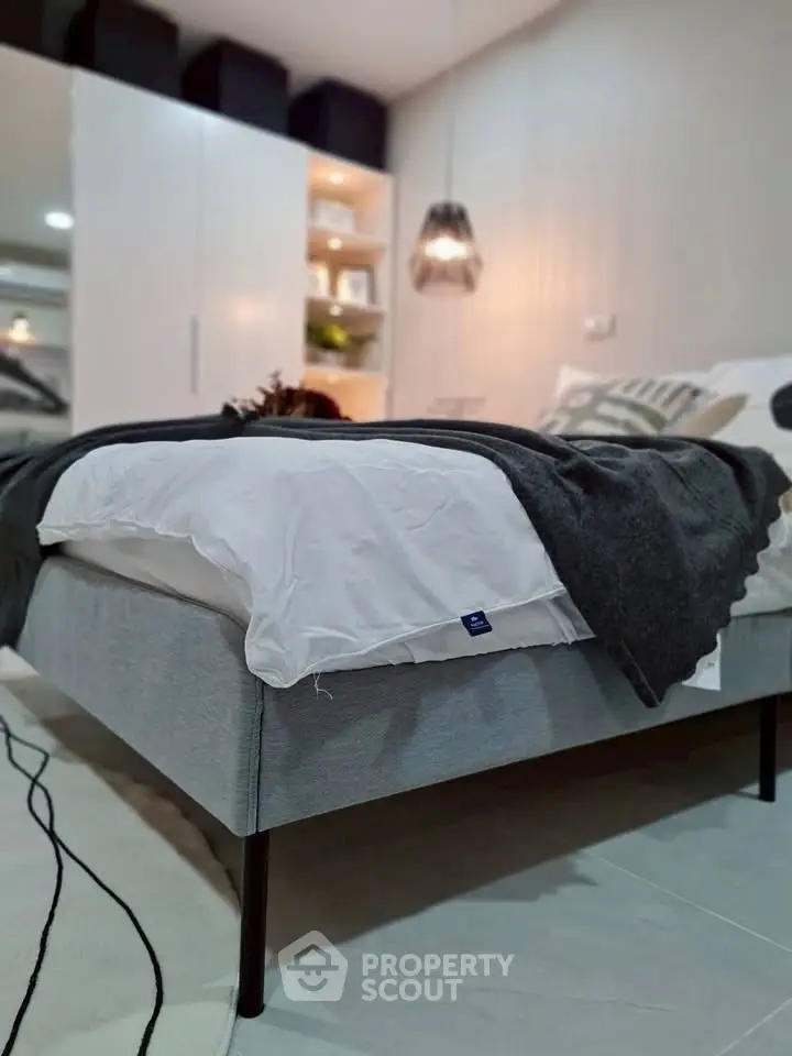 Modern bedroom with stylish decor and cozy bedding