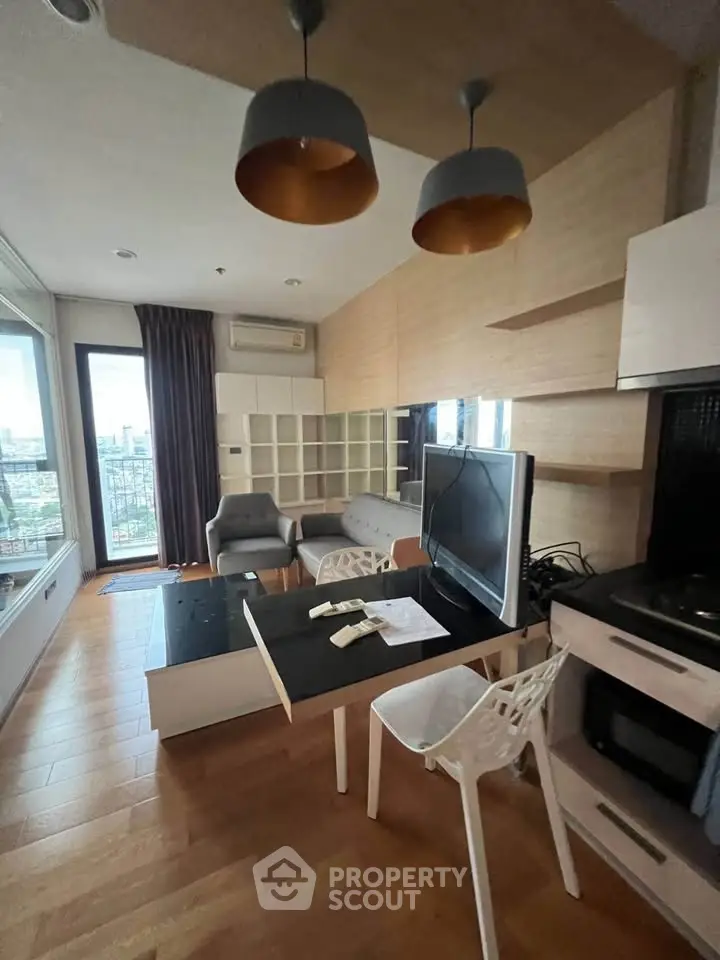 Modern living room with stylish furniture and city view, featuring open layout and contemporary design.