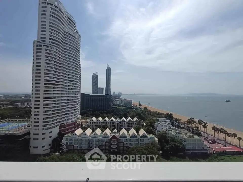 Stunning beachfront view with modern high-rise buildings and serene ocean backdrop.