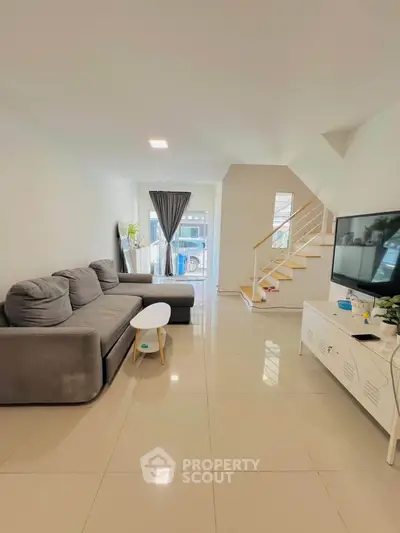 Spacious modern living room with sleek furniture and natural light