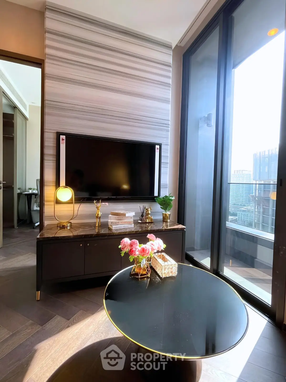 Luxurious living room with modern decor and city view balcony, perfect for urban living.