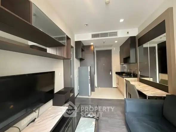 Modern living room with sleek furniture and open kitchen layout