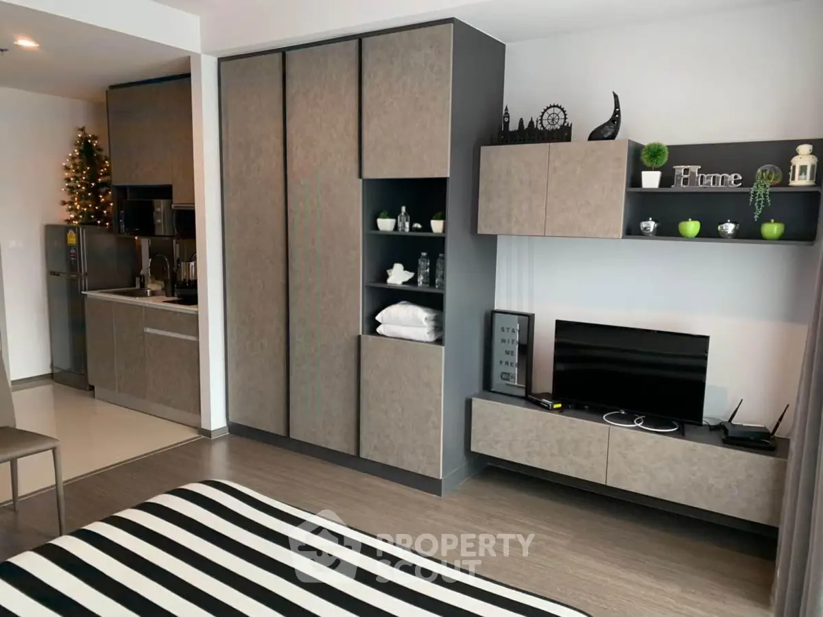 Modern studio apartment with sleek kitchen and stylish decor