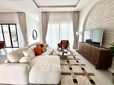 Luxurious modern living room with elegant decor and large windows