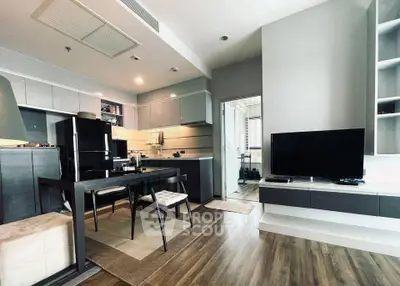Modern open-layout kitchen and living room with sleek design and wooden flooring