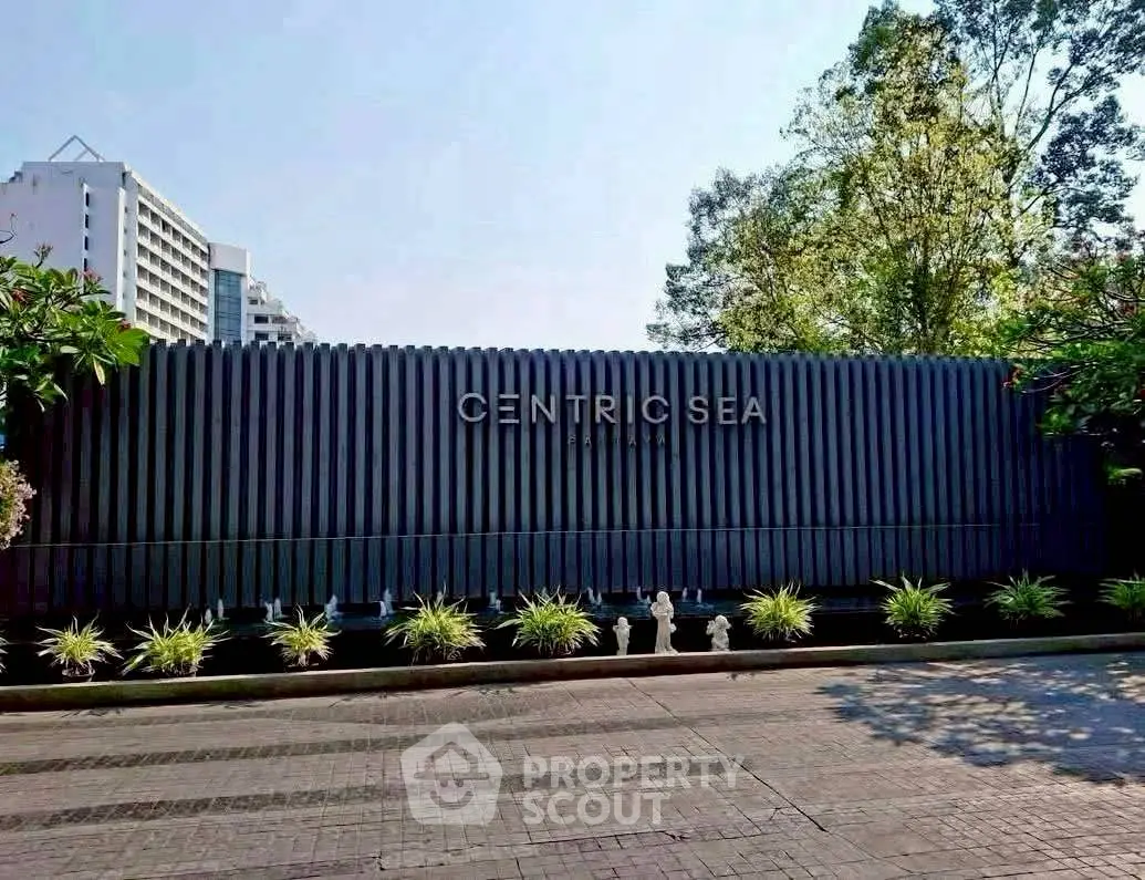 Modern building entrance with sleek design and lush greenery