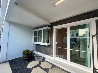 Modern home exterior with sliding glass doors and stylish stone accents