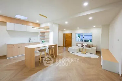 Spacious open-plan living room with modern kitchen and stylish decor