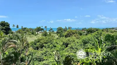 Stunning tropical landscape with lush greenery and ocean view, perfect for serene living.