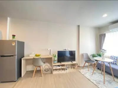 Modern living room with sleek furniture and natural light, featuring a cozy seating area and stylish decor.