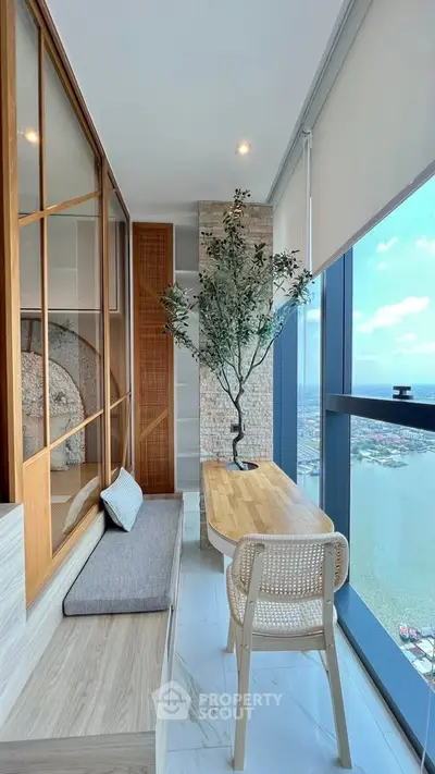 Stunning high-rise balcony with panoramic city and river views, featuring modern decor and natural light.