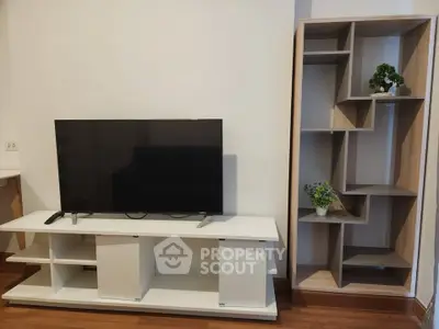 Modern living room with sleek TV stand and stylish shelving unit, perfect for contemporary home decor.