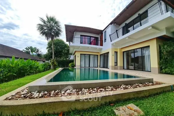 Luxurious modern villa with private pool and lush garden, perfect for serene living.