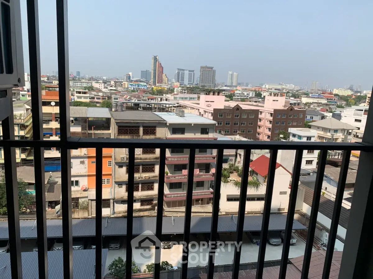 Stunning cityscape view from a high-rise balcony with urban skyline.
