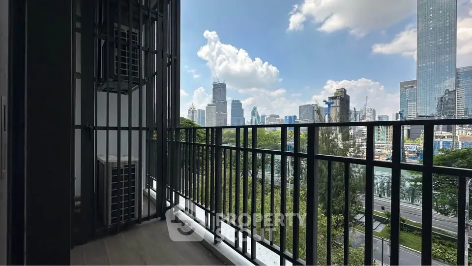Spacious balcony with stunning city skyline view, perfect for relaxation and enjoying urban living.