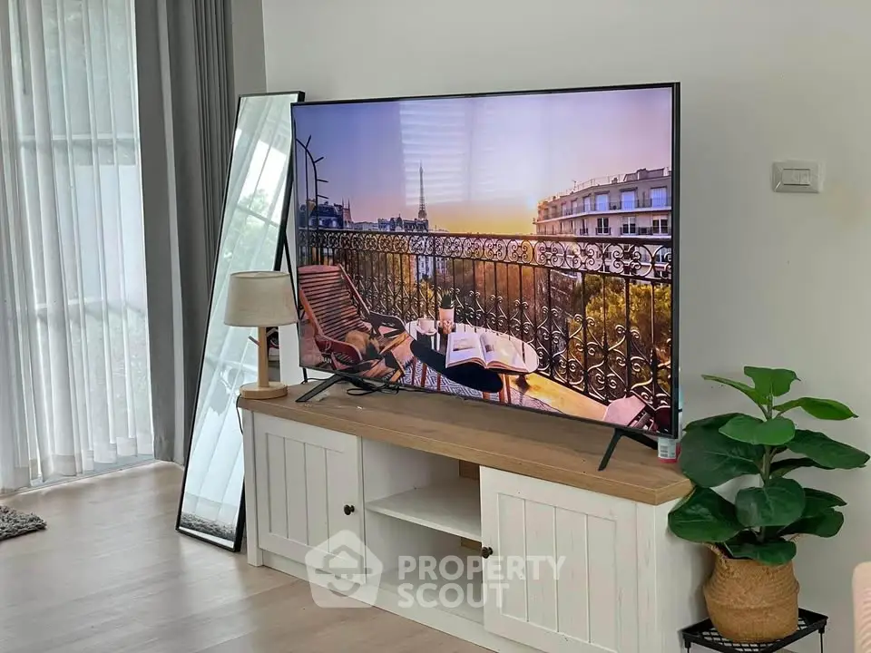 Modern living room with large TV and stylish decor