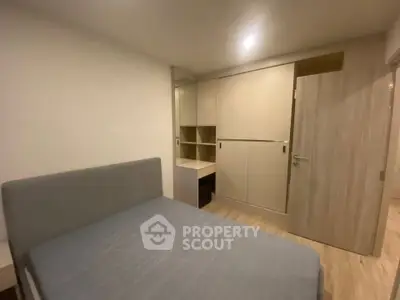 Modern bedroom with sleek built-in wardrobe and cozy bed in minimalist design.