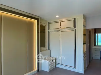 Modern bedroom with built-in storage and elegant lighting