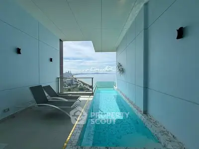 Luxurious balcony with private pool and stunning ocean view in high-rise building.