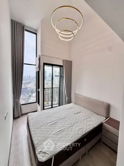 Modern bedroom with high ceiling and city view from large windows.