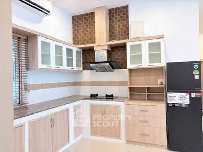 Modern kitchen with gas stove, wooden cabinets, and sleek design
