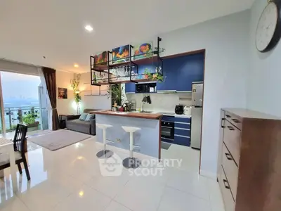 Modern open-layout kitchen and living room with city view and stylish decor.
