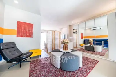 Modern living room with stylish decor and mirrored storage