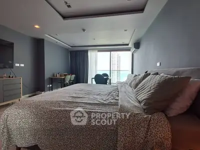 Spacious modern bedroom with large windows and city view, featuring stylish decor and comfortable bedding.