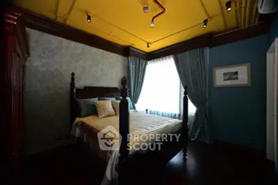 Luxurious bedroom with elegant decor and large window draped in rich curtains.