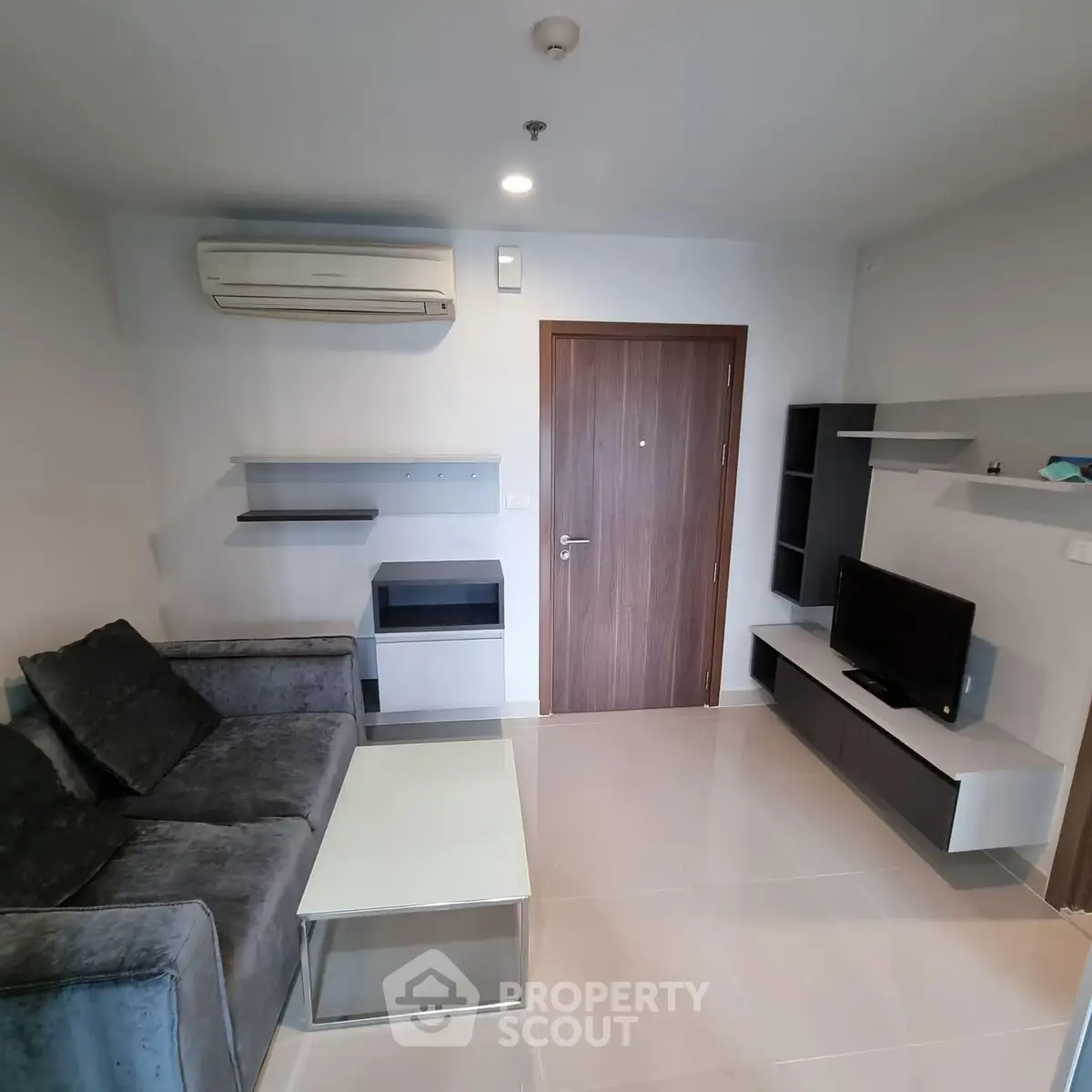 Modern living room with sleek furniture and air conditioning in a cozy apartment.