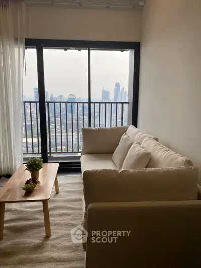 Modern living room with cozy sofa and stunning city view from large window.