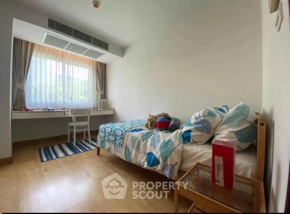 Charming bedroom with cozy single bed and natural light, perfect for a peaceful retreat.