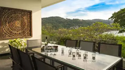 Luxurious outdoor dining area with stunning mountain and sea views, perfect for entertaining.