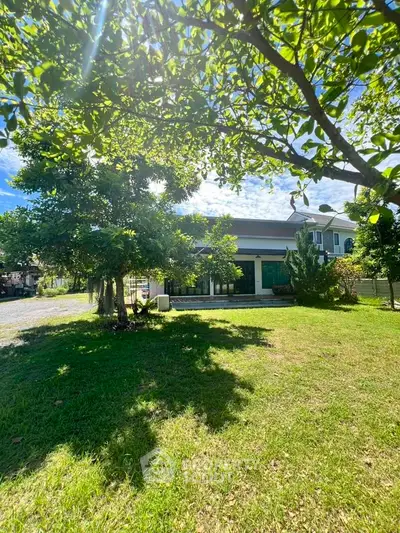 Charming suburban home with lush green lawn and mature trees