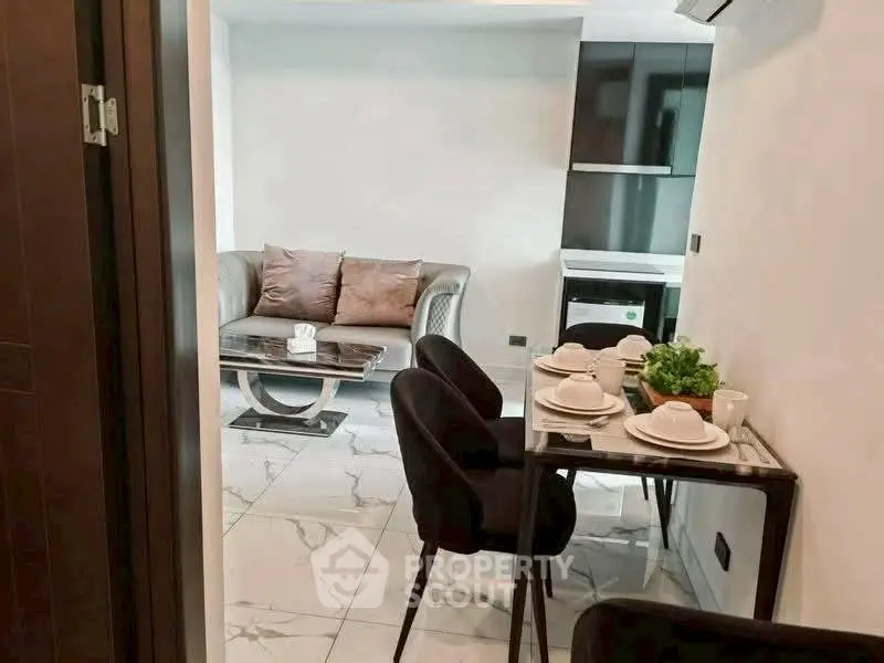 Modern living room with dining area and sleek kitchen design