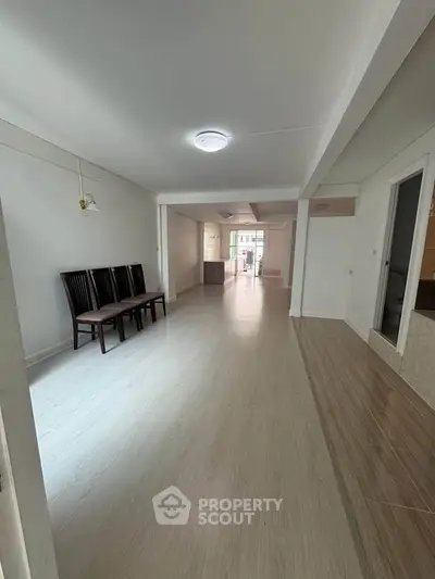 Spacious open-plan living area with modern flooring and ample natural light.