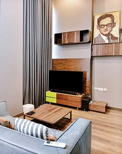Modern living room with stylish decor and entertainment setup, featuring a sleek TV unit and contemporary furniture.