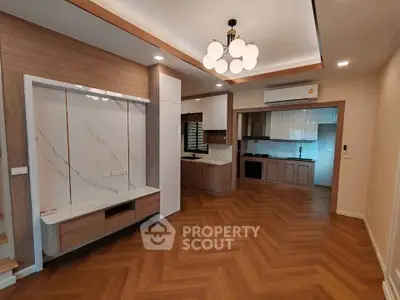 Modern open-plan living room with stylish kitchen and elegant wood flooring