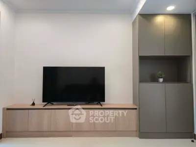 Modern living room with sleek TV unit and stylish cabinetry, perfect for contemporary living.