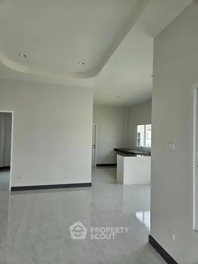 Spacious modern interior with sleek white walls and open layout, perfect for customization.