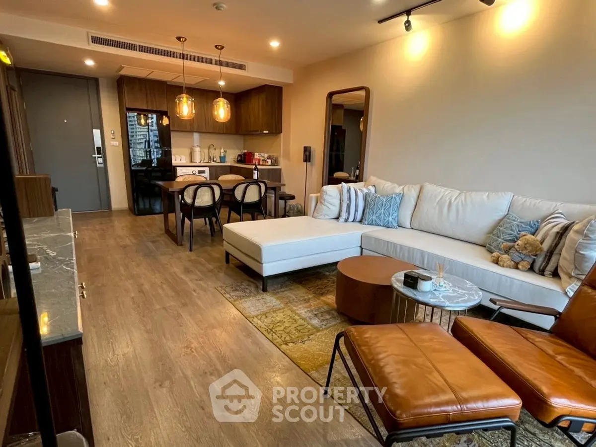 Modern living room with stylish furniture and open kitchen layout