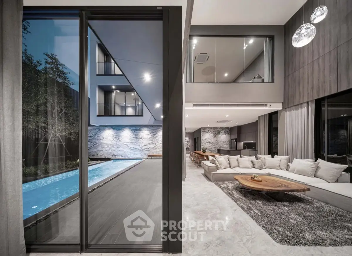 Luxurious modern living room with pool view and elegant interior design