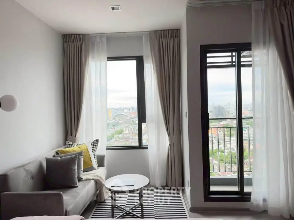 Modern living room with city view and stylish decor in high-rise apartment