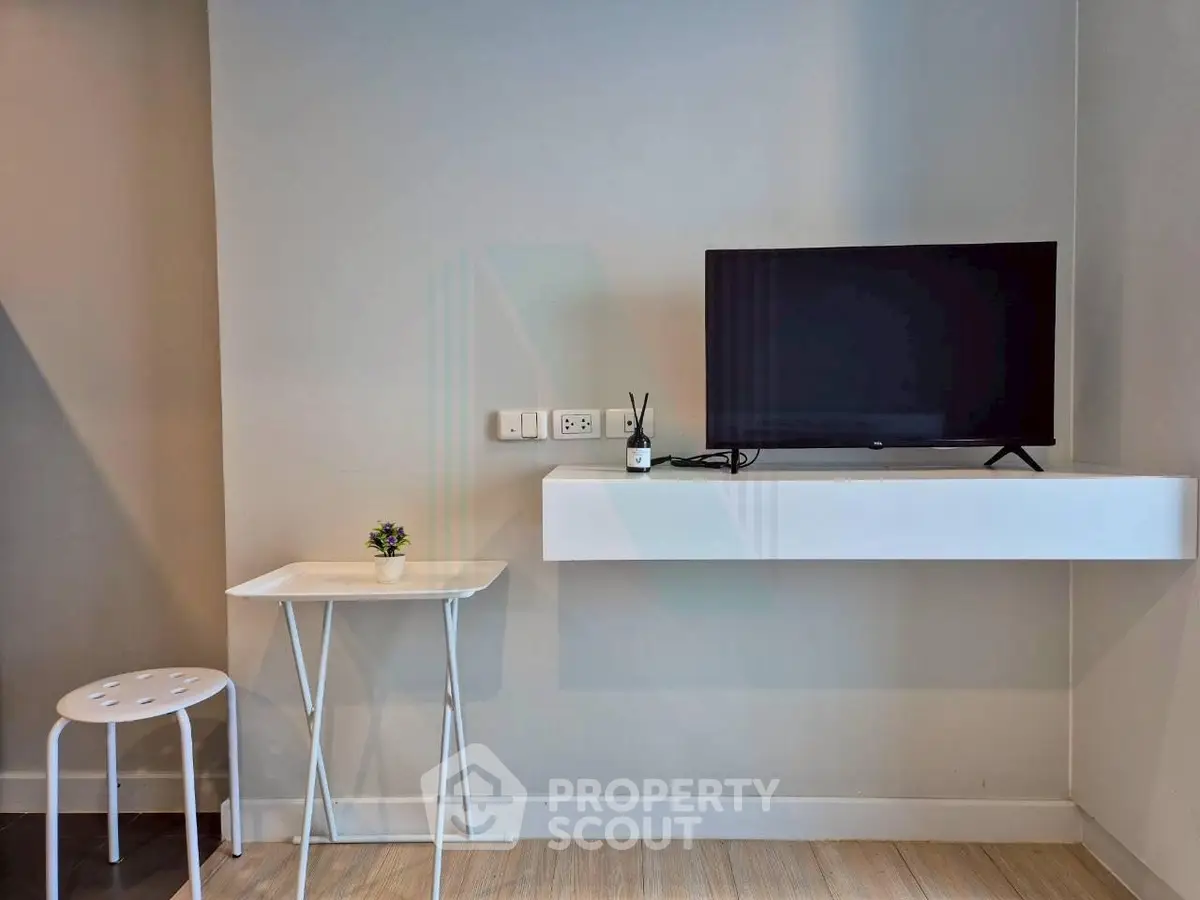 Modern minimalist living room with wall-mounted TV and sleek furniture