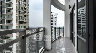 Spacious high-rise balcony with stunning city views and modern glass railing.